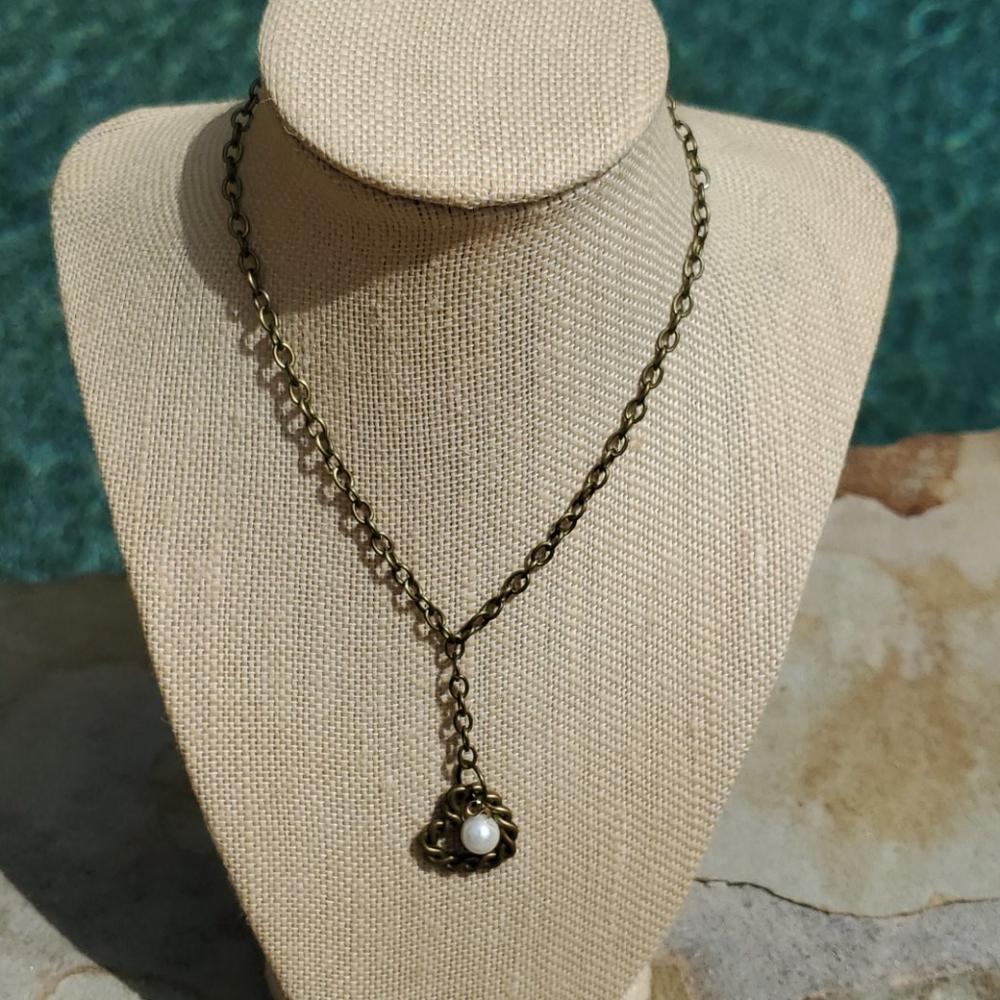 Bronze plated necklace with heart and pearl charm.